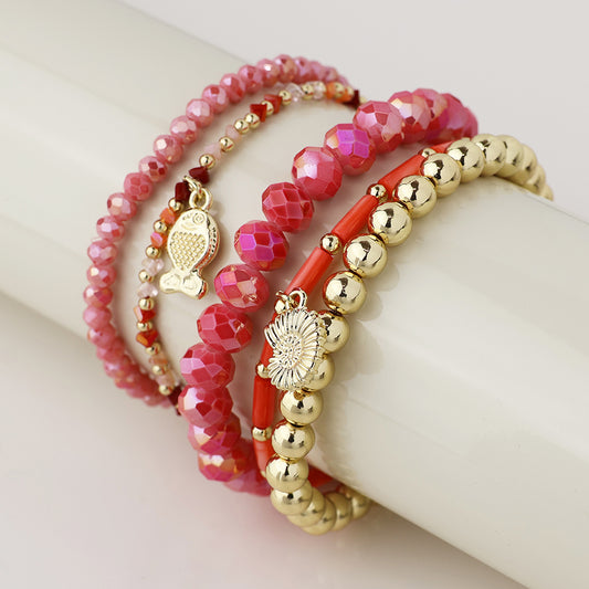 POM Pink and gold bead bracelet stack with fish and shell