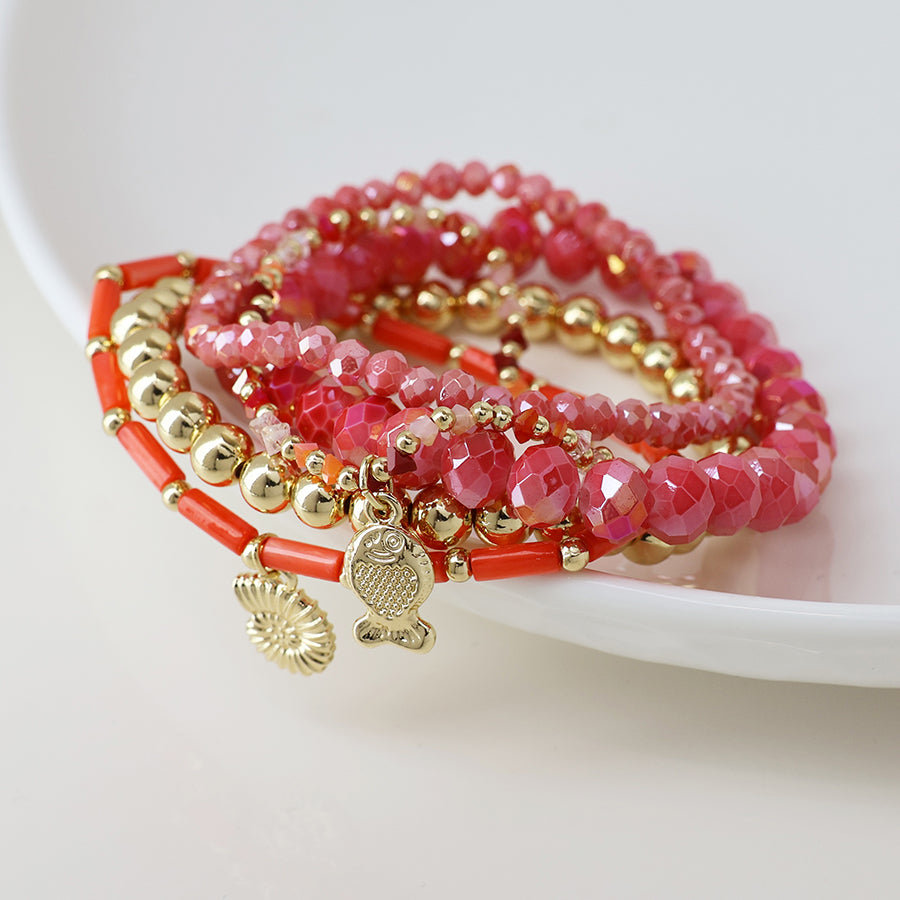 POM Pink and gold bead bracelet stack with fish and shell