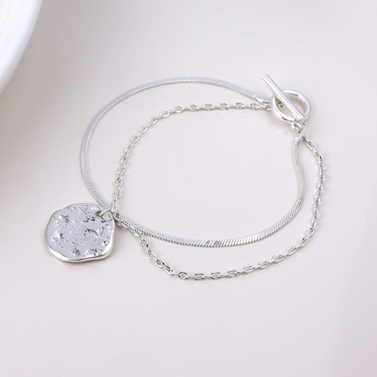 POM Solstice worn silver plated textured disc layered chain bracelet