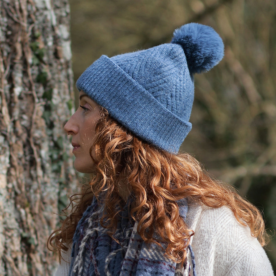POM Charlotte Herringbone Knit Recycled Blend Bobble Hat in Dusky Blue