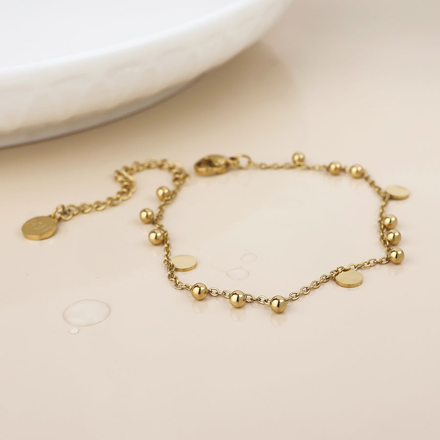 POM Waterproof gold plated bead and disc charm bracelet