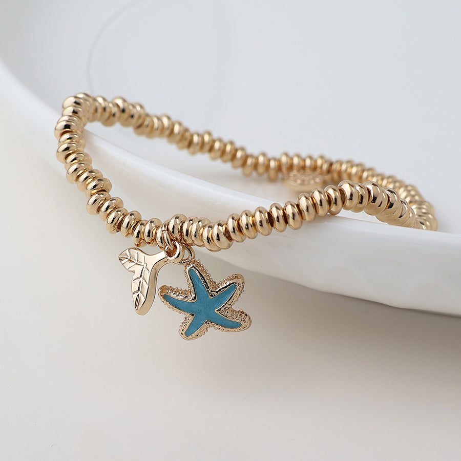POM Golden whale tail and blue starfish charm bracelet