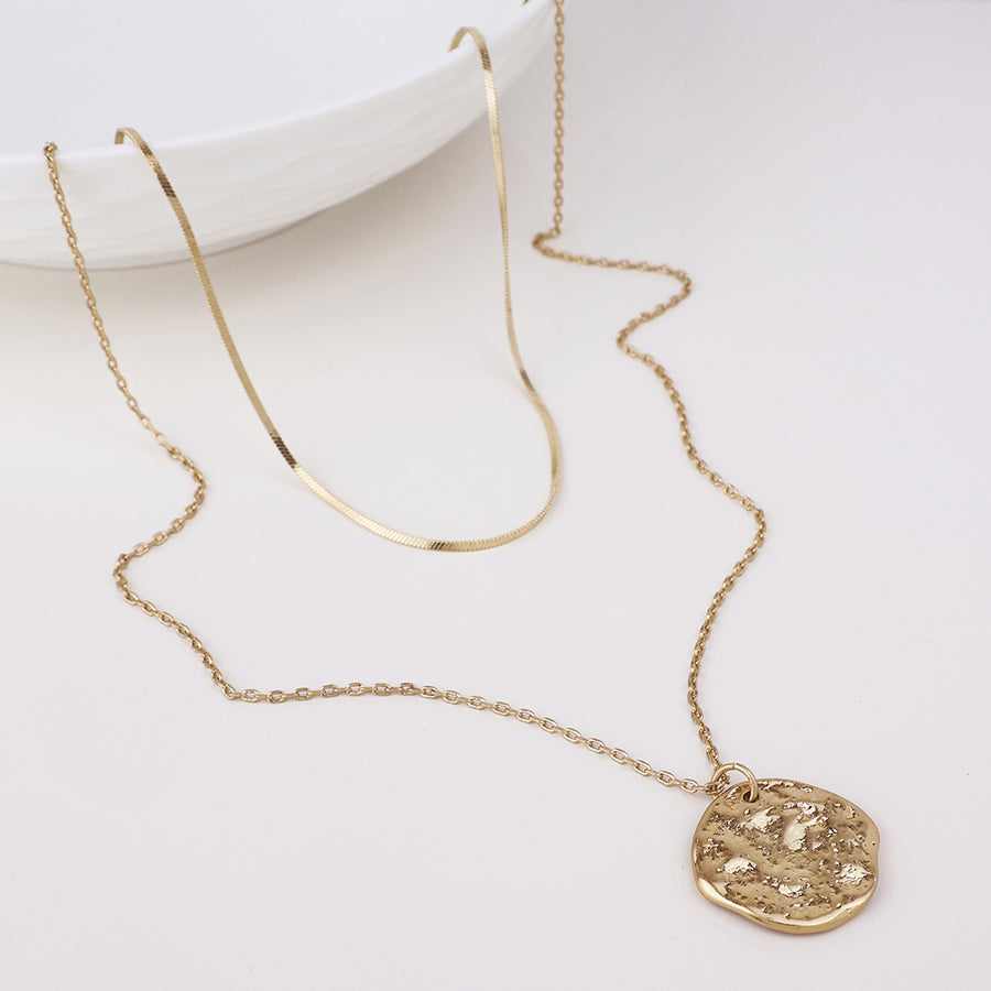 POM Solstice worn golden textured disc layered chain necklace