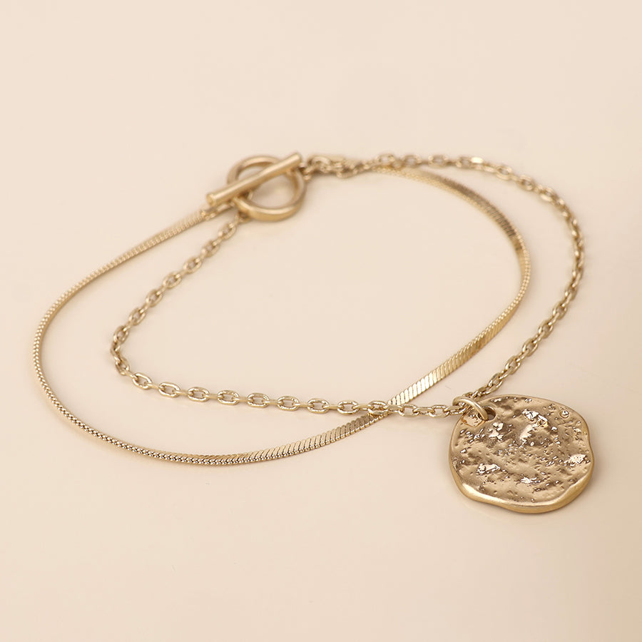 POM Solstice worn golden textured disc layered chain bracelet