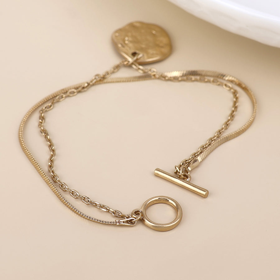 POM Solstice worn golden textured disc layered chain bracelet