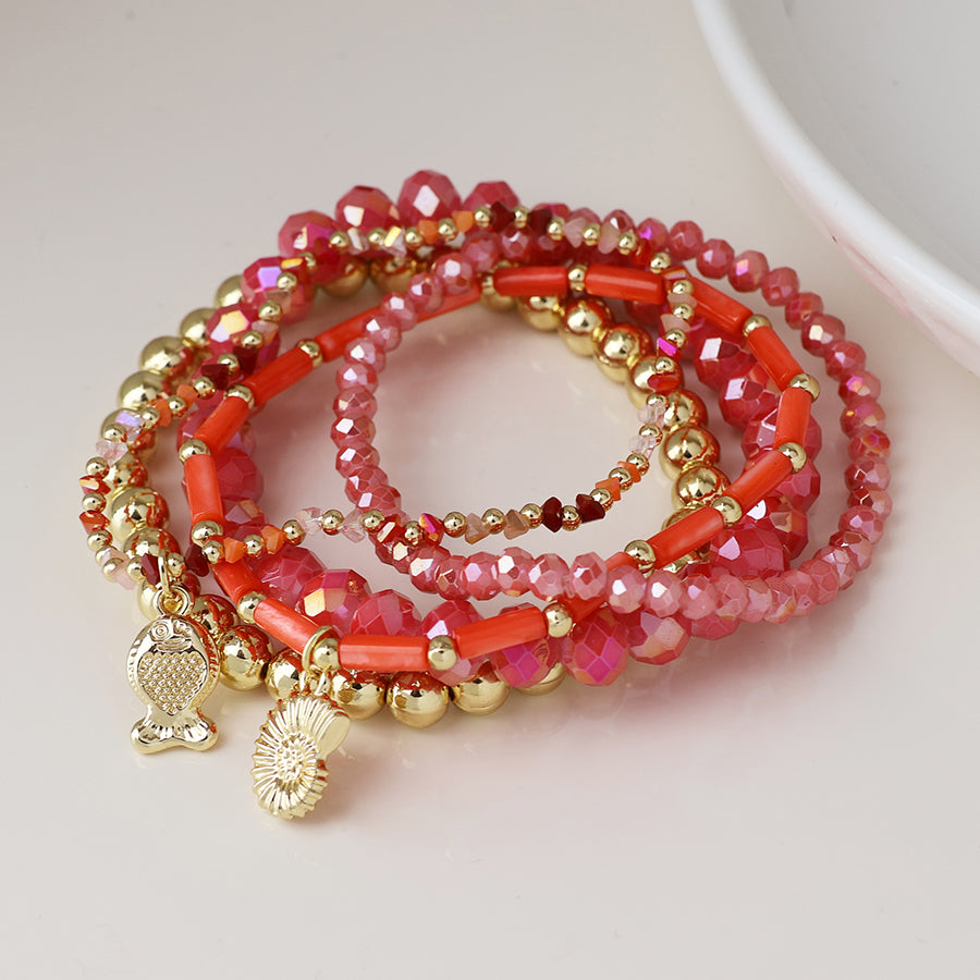 POM Pink and gold bead bracelet stack with fish and shell