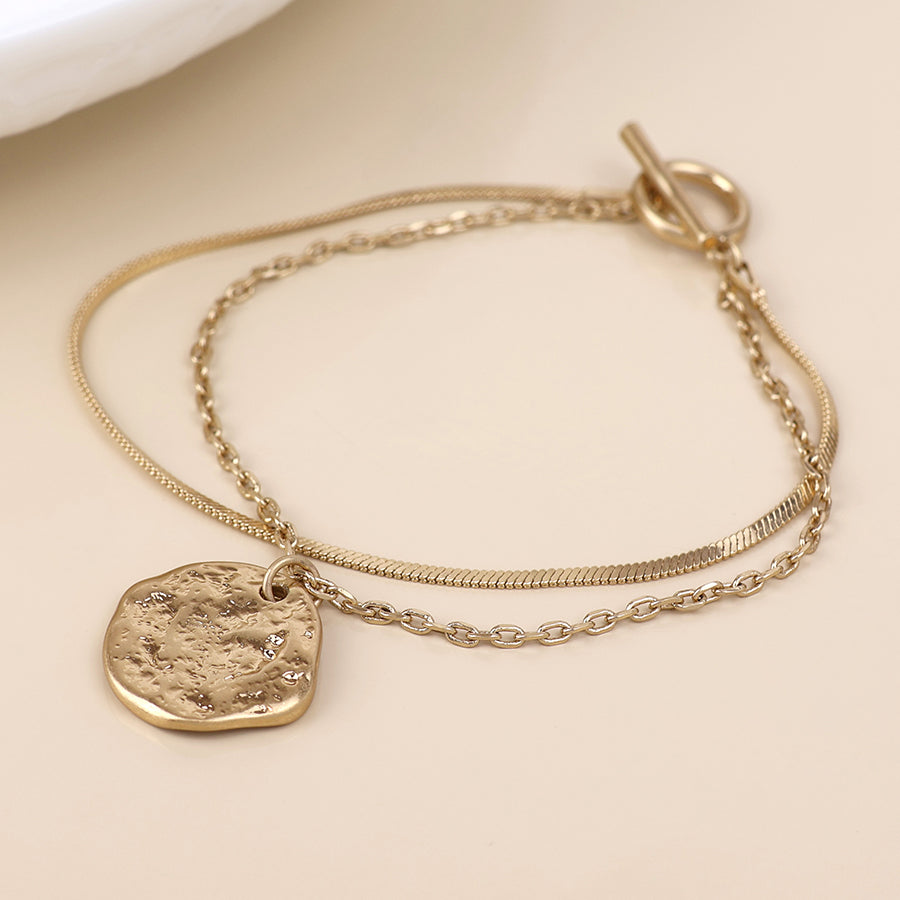 POM Solstice worn golden textured disc layered chain bracelet